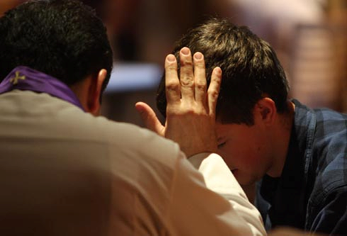 Man baptizing another man